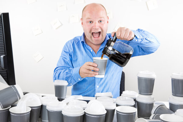 Happy businessman drinks way too much coffee