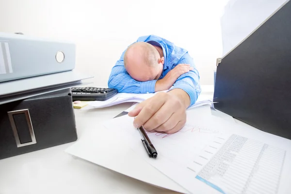 Overworked and tired businessman at the office — Stock Photo, Image