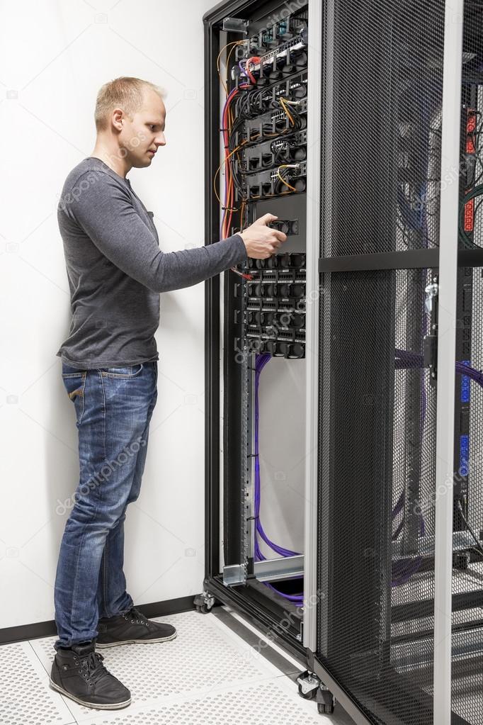 IT engineer building network rack in datacenter