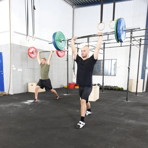 Clean and jerk workout at fitness gym center — Stock Photo, Image