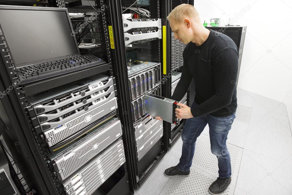 IT engineer installs blade server in datacenter