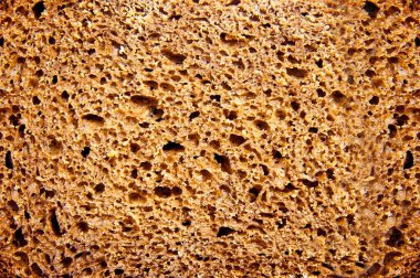 Siyah ekmeğin dokusu. Siyah ekmek yakından çekilir. Ekmek arkaplanı. Boşluğu kopyala