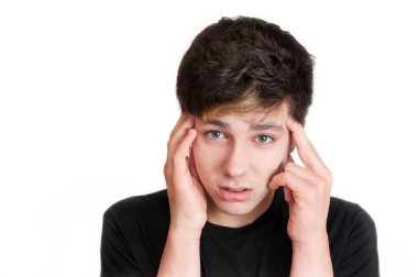 Üzgün bir çocuk başını tutuyor ve baş ağrısına katlanıyor. Dişlerinde diş teli olduğu ve dişlerini ve çenesini sıktıkları için kafası ağrıyor. İzole edilmiş