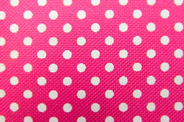 Pink background made of cloth with white circles. A good background for presentation and various designs