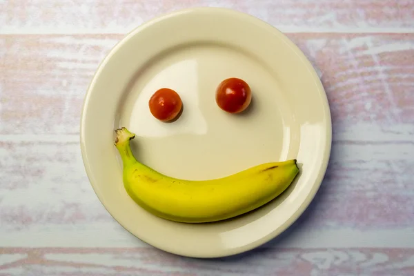 White round plate with a smiley face — Stock Photo, Image