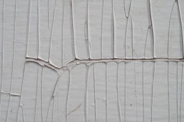 Katmanlı bir dokunun fotoğrafı. Yapışkan sıvı kuruduğunda doku çatlaklarla oluşur. Uzun düz çatlaklar geometrik desen oluşturur.