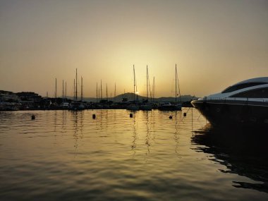 Olbia, Sardinya / İtalya - 2019 / 8 / 21: Günbatımında marina di Olbia limanı ve yat marinasının panoramik manzarası