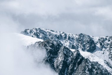 Karlı dağ zirveleri ve bulutlu ve sisli buzullar. Kış kar manzarası doğa yolculuğu. Port d 'Envalira, GrandValira, Pirineus, Pyrenees, Andorra.