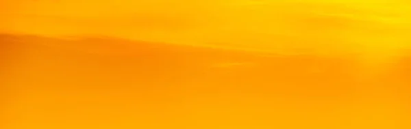 Orange sky of a sunset or sunrise. Beautiful panoramic background of warm color of sunset or sunrise. Harmonious pastel color background. Calm, peace.