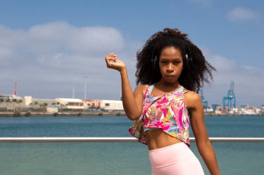 young black dancer on roller skates with maritime background