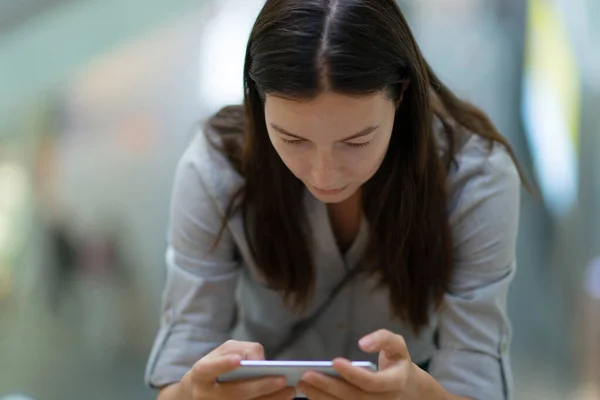 Fiatal nő használ egy okostelefon dolgozni és kommunikálni, — Stock Fotó