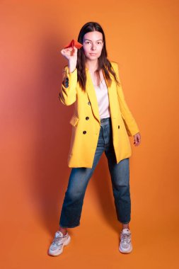 Kağıt uçak, rüya yolculuğu konsepti. Sarı elbiseli esmer kadın.