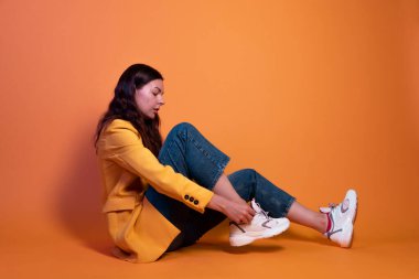 Genç bayan beyaz spor ayakkabılarını giyer. Rahat ve şık ayakkabılar.,