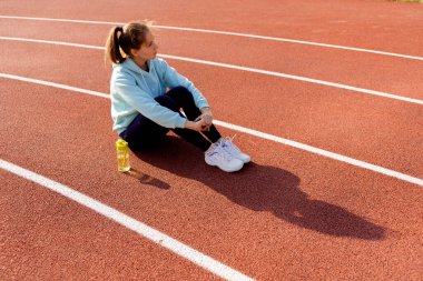 Sokakta antrenman yapan genç bir bayan sporcu sokak platformunda antrenman yapıyor..