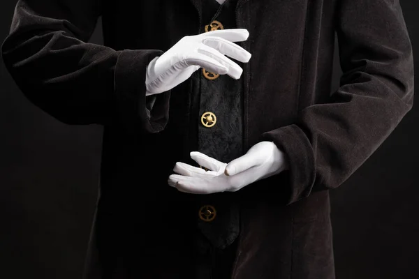 Hand gestures. Showman or magician illusionist in white gloves on a black background. — Stock Photo, Image