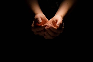 Begging, empty palms, outstretched hands. Concept of social disadvantage, black background. clipart