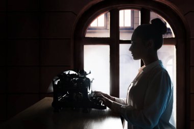 young beautiful woman author at a typewriter, writes a text, clipart