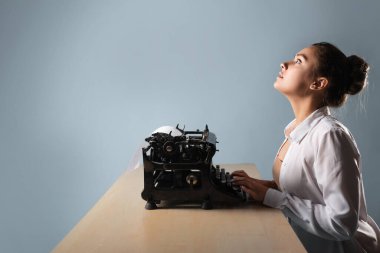young beautiful woman author at a typewriter, writes a text, clipart
