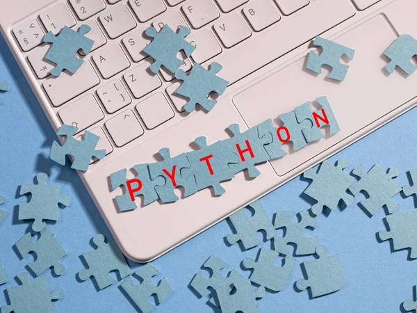 The puzzle pieces are assembled into the word Python,