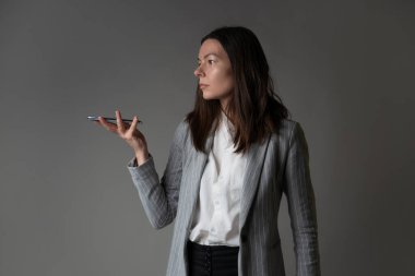 Ceket ve pantolon giymiş sıradan bir iş kadını.