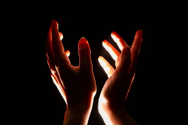 Magical reddish light shines from above on the palm of your hand. Hands reaching up, striving for high, concept. — Stock Photo, Image