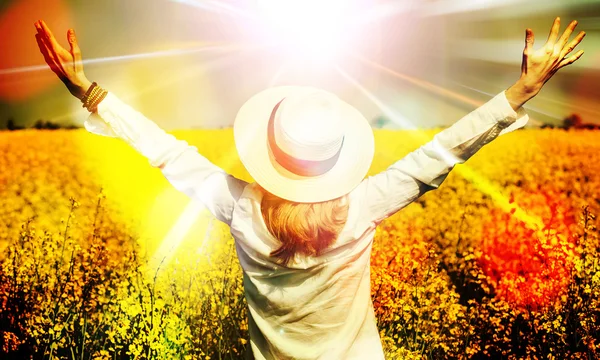 Happy beautiful girl in front of  rapeseed field in bloom with open hands greeting sunny spring day ,freedom and prosperity concept — Stock Photo, Image