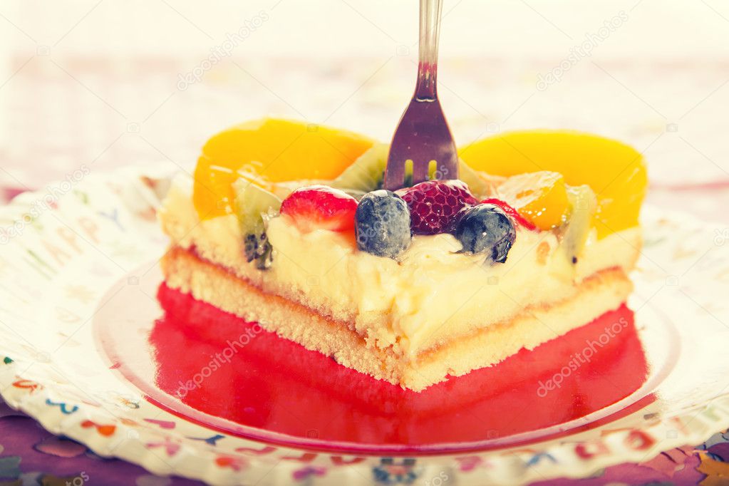 fruit cake with cream, strawberries and blueberries