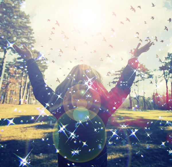 Young girl spreading hands with joy and inspiration facing the sun,sun greeting,freedom concept,bird flying above sign of freedom and liberty — Stock Photo, Image