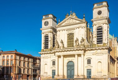 MONTAUBAN, FRANCE - JUNE 25,2021 - View at the Cathedral of Notre Dame in the streets of Montauban. Montauban is a commune in  Occitanie region in southern France.  clipart