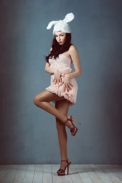 Schöne sexy Frau mit langen seidigen Haaren posiert, Mädchen in das Bild des Kaninchens in rosa Kleid bad bunny sly sexy Look Playboy für Männer — Stockfoto