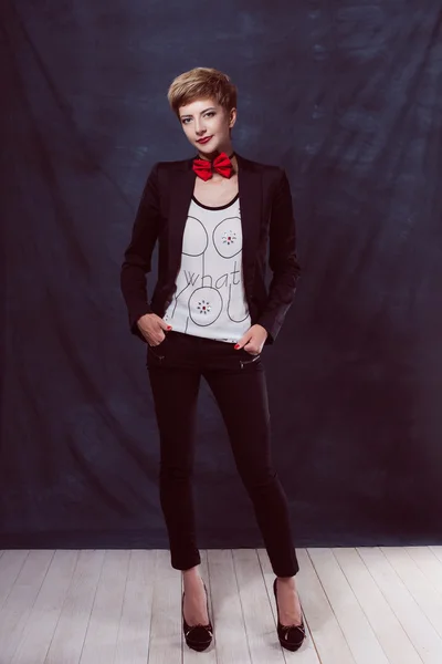 Beautiful sexy girl woman in a suit with a bow tie shoes success thoughtful look smile — Stock Photo, Image