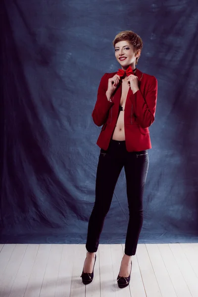 Portrait of a beautiful business woman reached victory or vyigrasha holding hands in fists first place in the red jacket and bow tie chest Smile and teeth — Stock Photo, Image