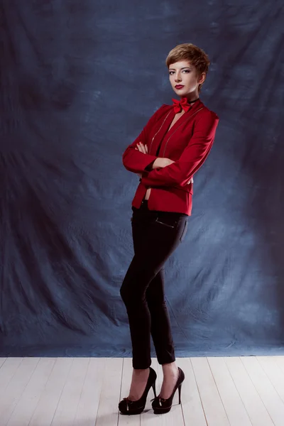 Portrait of a beautiful business woman reached victory or vyigrasha holding hands in fists first place in the red jacket and bow tie chest Smile and teeth — Stock Photo, Image