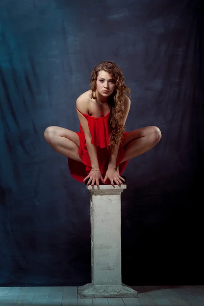 Joven hermosa y encantadora chica en rojo está bailando con una figura esbelta bailarina de cuerpo de plástico con gimnasta de pelo realiza cordel rizado ringlet — Foto de Stock