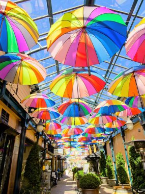 Sidney BC, Canada - May 13, 2021. Street gallery of shops covered with glass roof and decorated with colorful umbrellas