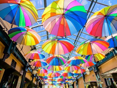 Sidney BC, Canada - May 13, 2021. Street gallery of shops covered with glass roof and decorated with colorful umbrellas