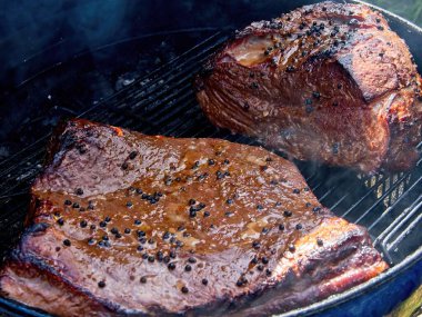 Kömür içicinin içinde baharatlarla kaplı iki büyük et parçası.