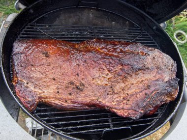 Packer brisket smoked on the charcoal grill