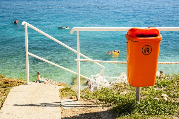 Papperskorgen kan nära havsstranden. — Stockfoto