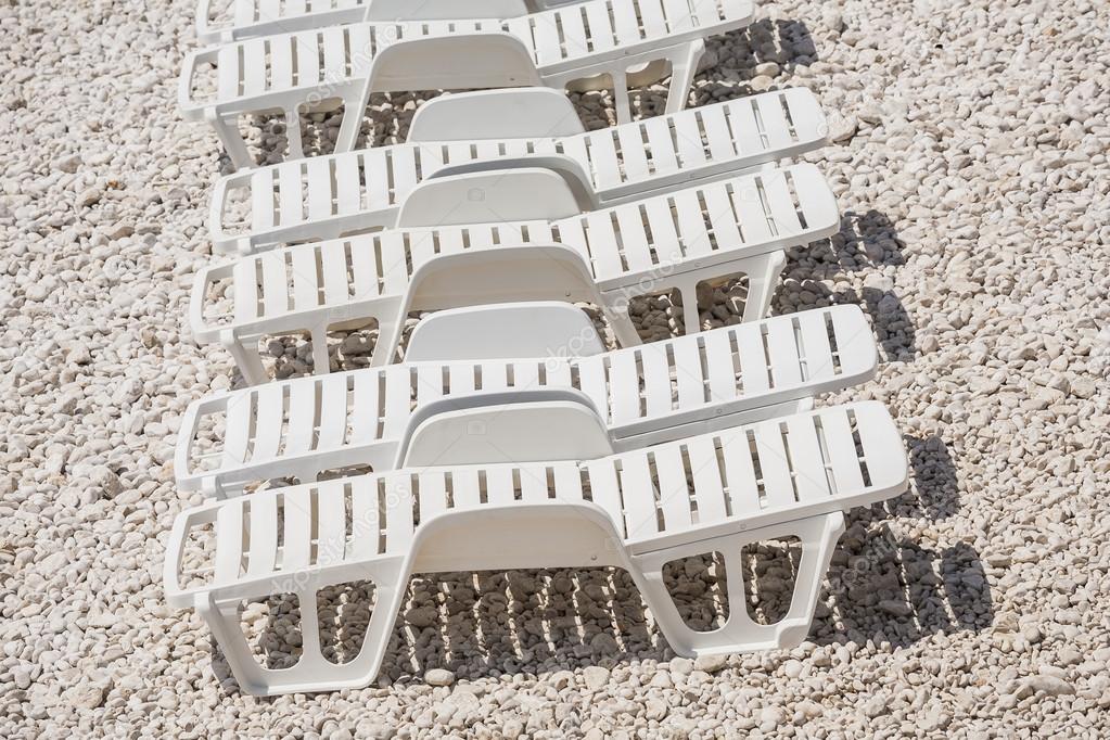 Sun loungers on beach.