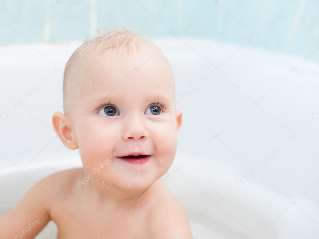 Cute one year old child taking a  bath