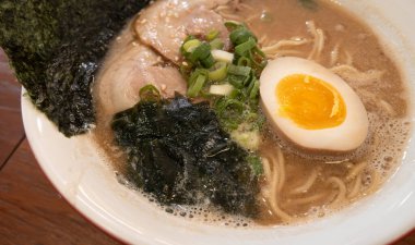 Rich tonkotsu ramen with char siu, soft-boiled egg, and seaweed in a savory broth.