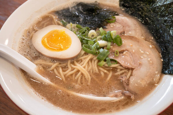 Rich tonkotsu ramen with char siu, soft-boiled egg, and seaweed in a savory broth.