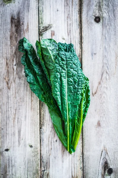 Kale on wooden background — Stock Image Kale on wooden background Stock Photo