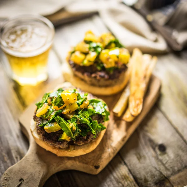 Hamburguesas caseras con papas fritas sobre fondo de madera —  Fotos de Stock