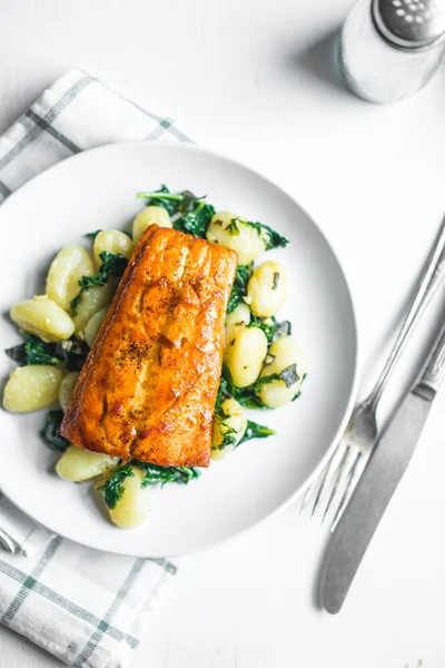 Grilled salmon with gnocchi and greens — Stock Photo, Image
