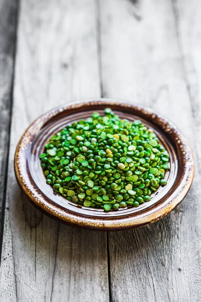 Organic split peas on wooden background — Stock Photo, Image