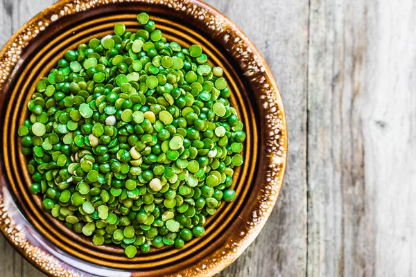 Organic split peas on wooden background — Stock Photo, Image