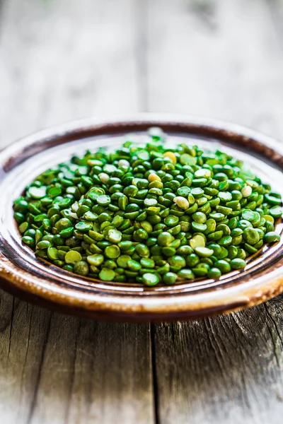 Organic split peas on wooden background — Stock Photo, Image