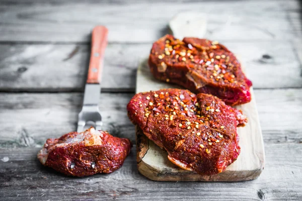 Raw meat on wooden background — Stock Photo, Image